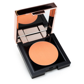 A small black square compact with a rose gold lid containing a mirror sits open, revealing a circle of warm, peachy coral powder Chic to Chic blush in “Making Me Blush.”